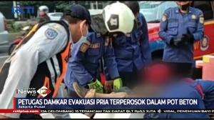 Pria Terjebak Dalam Pot Beton