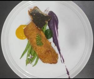 Pan seared salmon with purple sweet potato puree, crispy nori, sauted baby green been and served with salted egg hollandaise