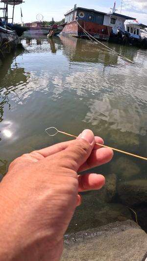 I'm catching shrimp using traditional tools inherited from my ancestors.