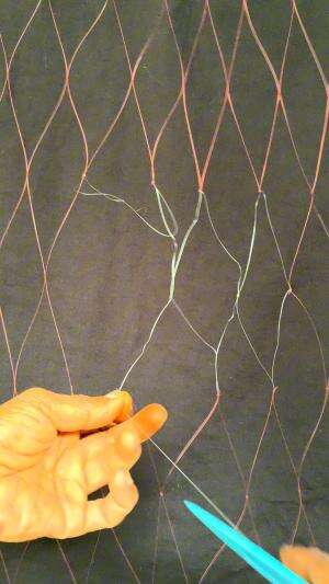 memperbaiki jaring ikan yang sudah rusak 